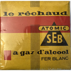 Le réchaud ATOMIC SEB à gaz d'alcool en fer blanc encore sous platique