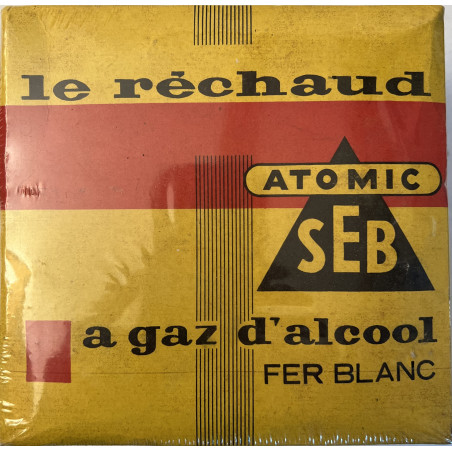 Le réchaud ATOMIC SEB à gaz d'alcool en fer blanc encore sous platique